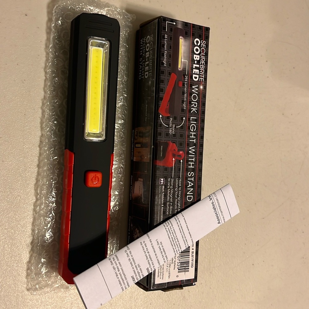 Con-led work light with stand. 2-in-1 flashlight and wide work light in 1 device